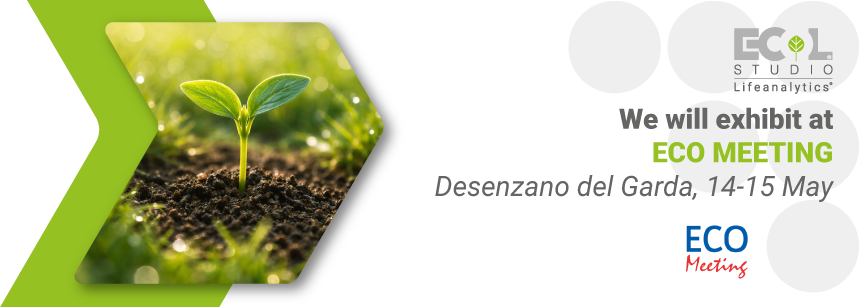 A plant sprout emerging from the soil in the middle of a grassy field, surrounded by blades of grass and dew